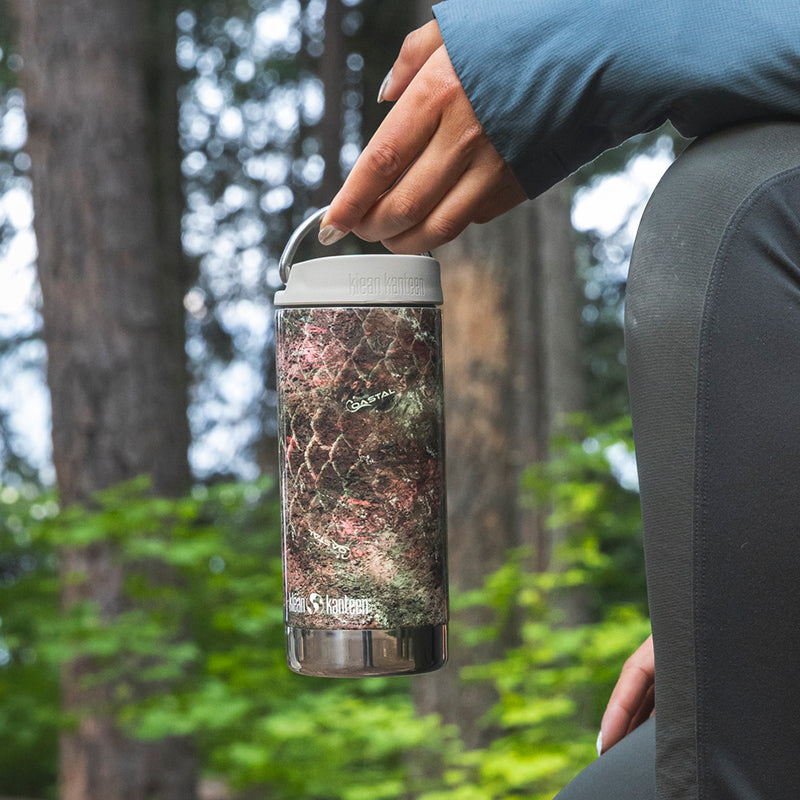 12oz-tkwide-with-cafe-cap-mossy-oak-n6 12oz_tumbler_mossyoak_rainbowtrout_hand_closeup_square.jpg