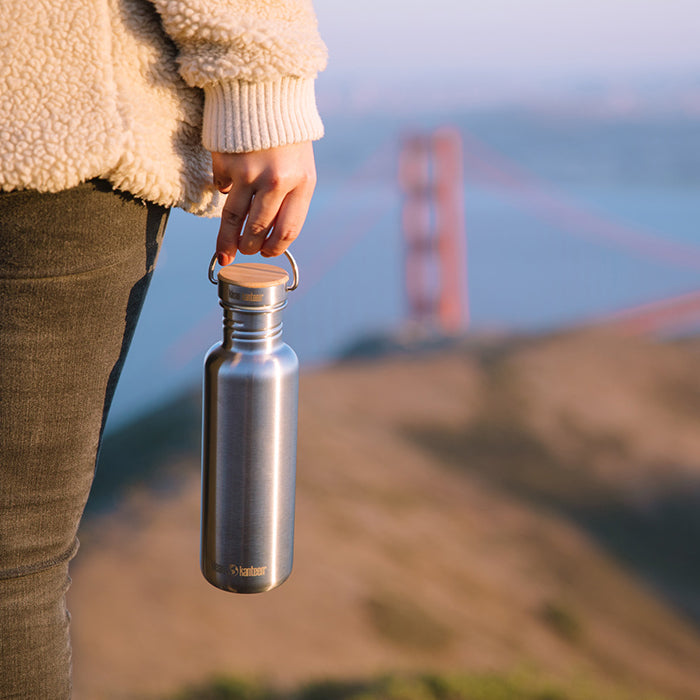27oz-reflect-with-bamboo-cap-t5 K27SSLRF-BS-BAMBOO_reflect_bottle_bridge_lifestyle.jpg